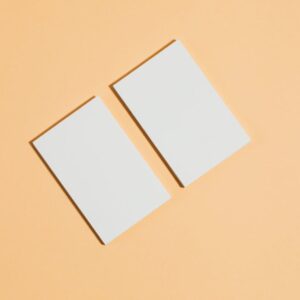 Flat lay of two blank cards on a peach background. Perfect for business concept layouts.